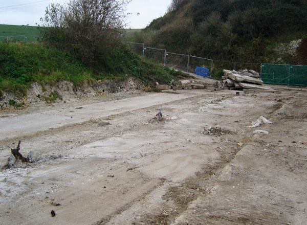 Geotechnical site investigation at Coombe Farm for retaining wall design and slope stability.